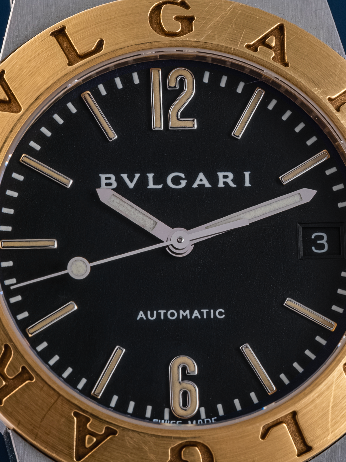 Bulgari watch with gold bezel and black dial