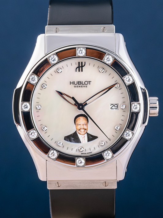 Hublot watch with diamond-studded bezel on a blue background