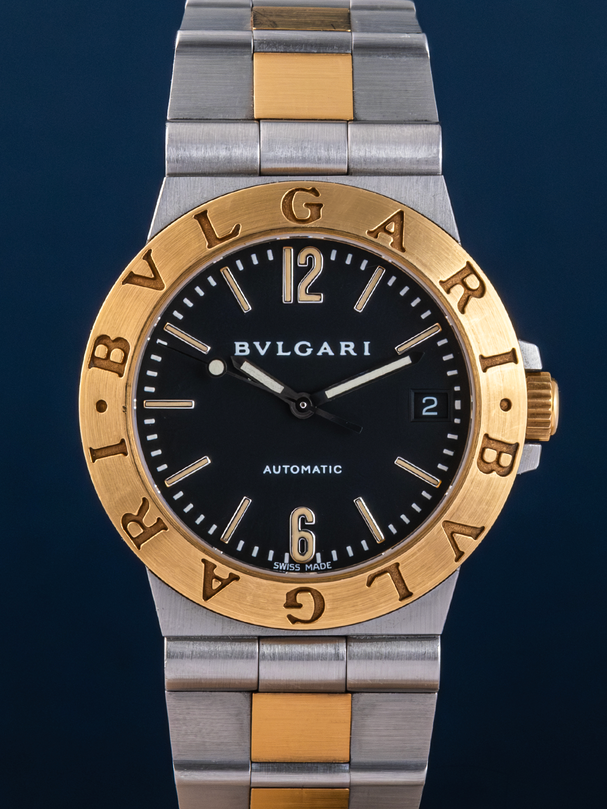 Bulgari watch with two-tone metal strap on a dark background