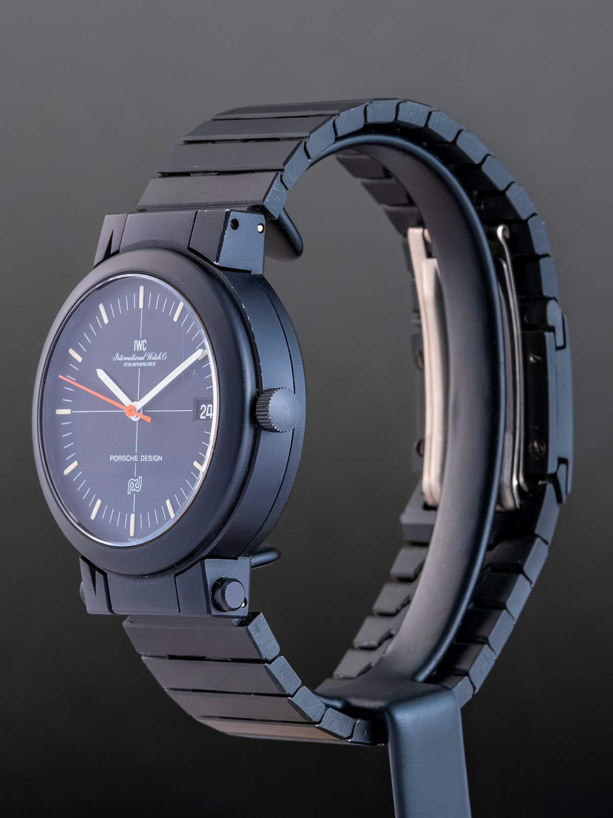 Blue wristwatch with a metallic band on a dark background