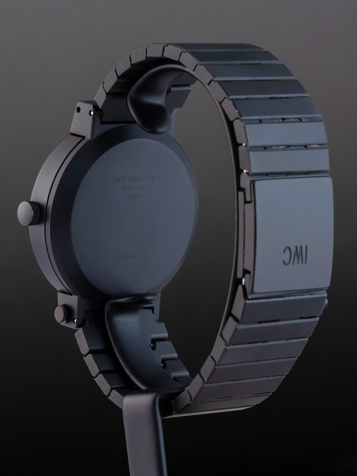 Close-up of a watch with a metallic band on a dark background