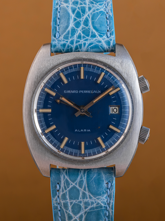 Watch with blue strap and blue dial on a brown background