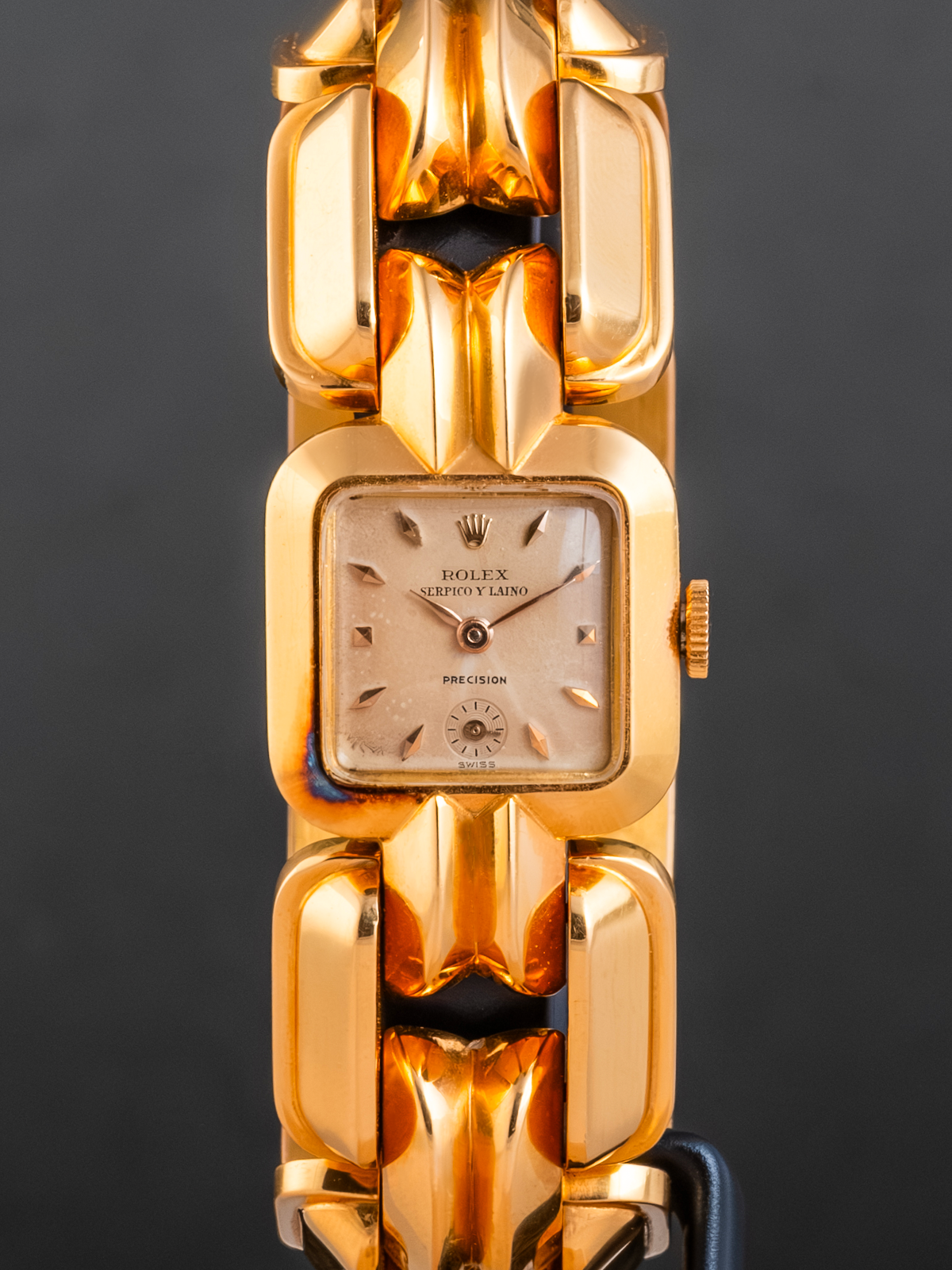 Gold Rolex watch on a dark background