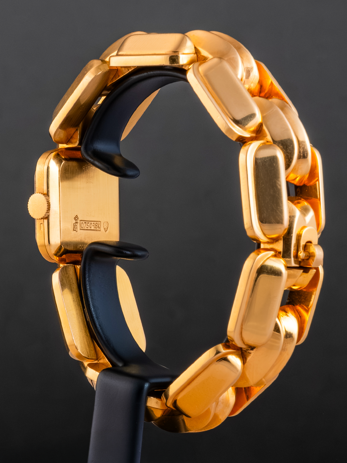Gold chain bracelet on a black background