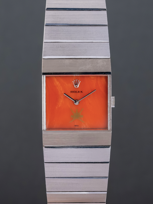Rolex watch with orange face and silver band on a dark background