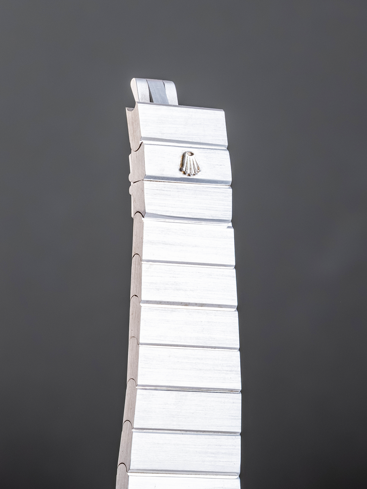 Tall white sculpture against a dark gray sky
