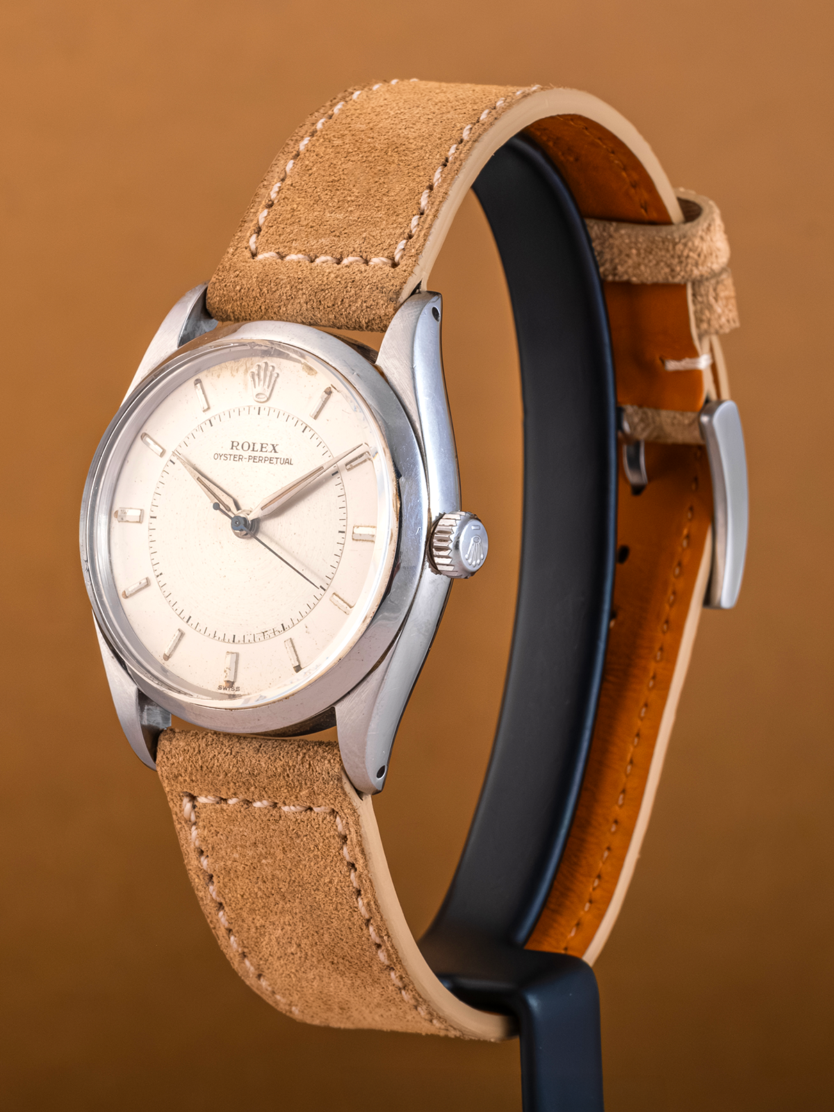 Watch with a brown leather strap on a brown background