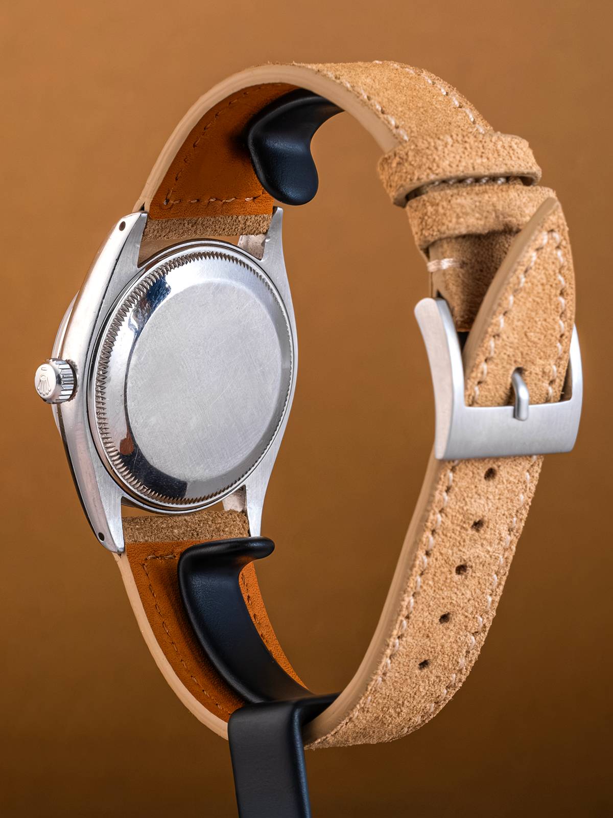 Watch with a brown leather strap on a brown background