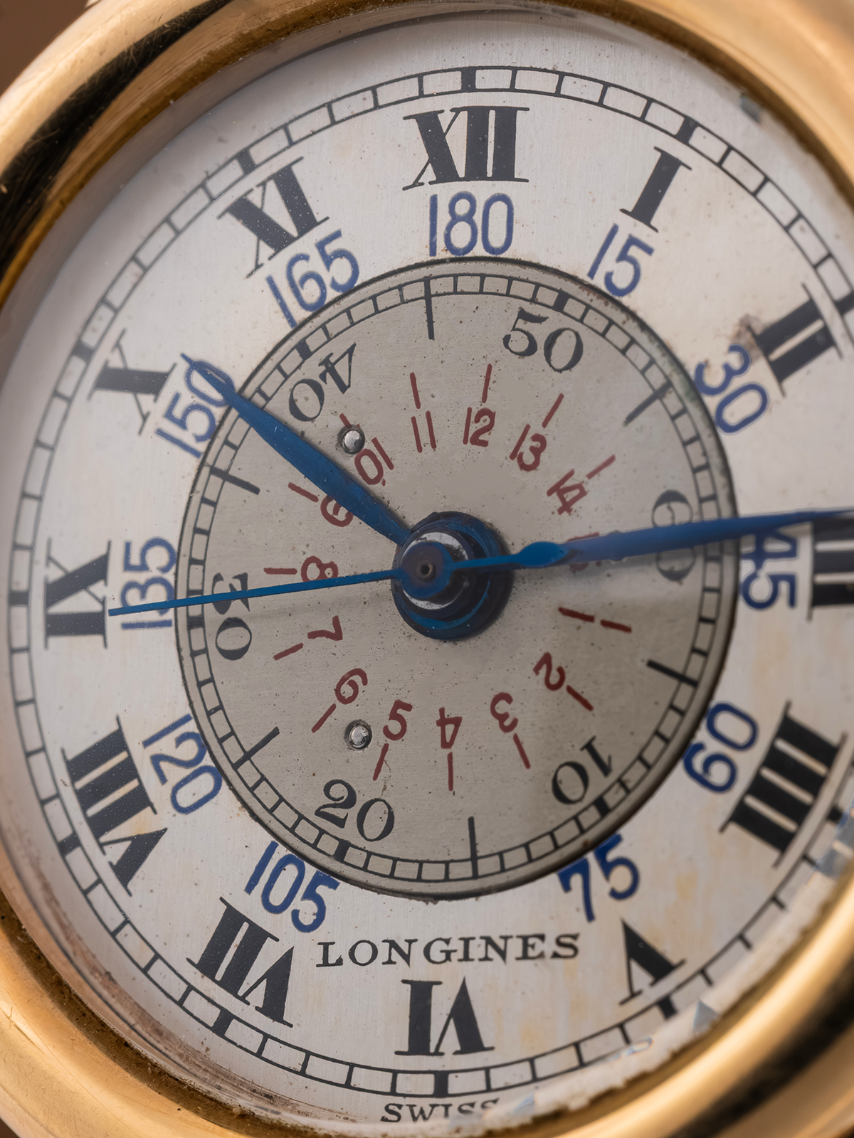 Close-up of a Longines pocket watch face with gold casing