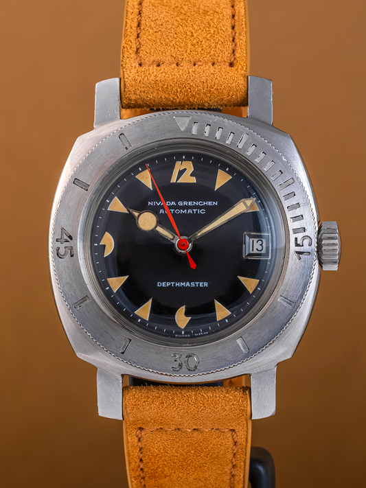 Watch with a brown leather strap and metallic case on a brown background