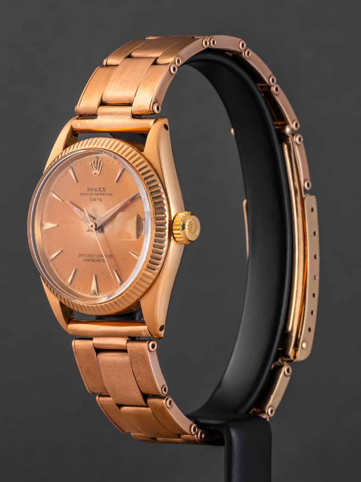 Rose gold watch with a dark background