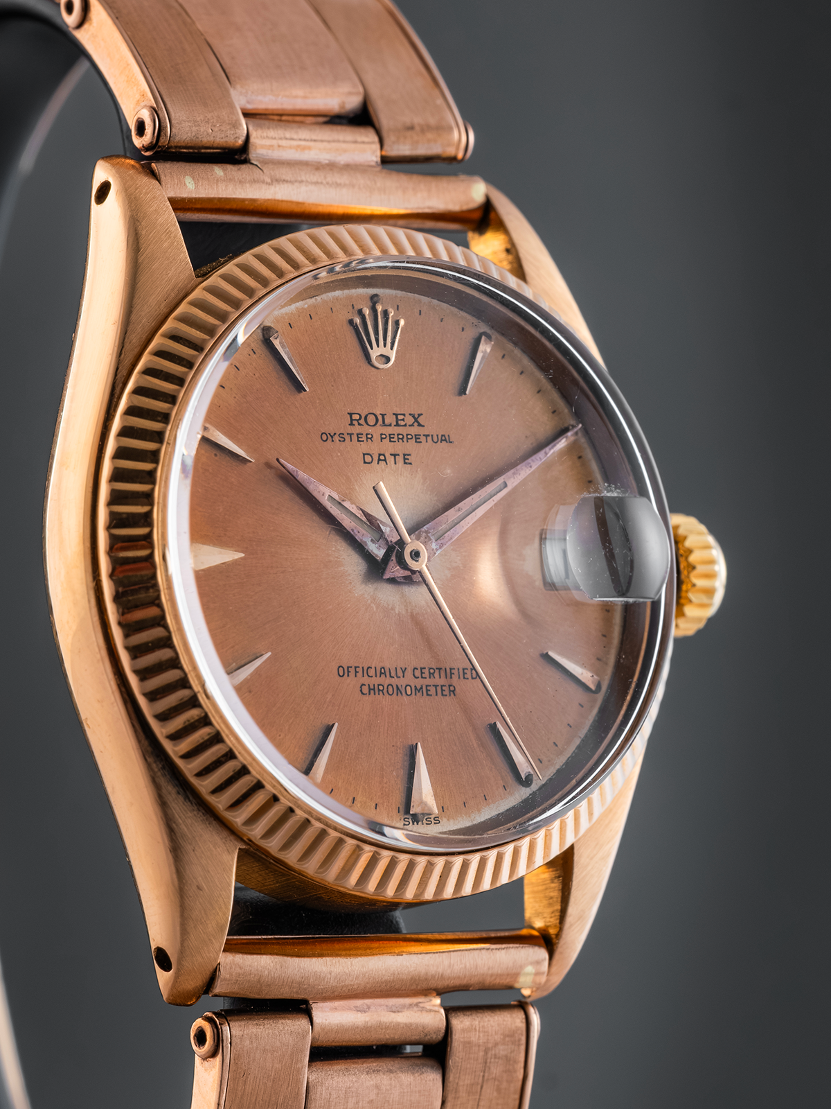 Rose gold Rolex watch on a dark background