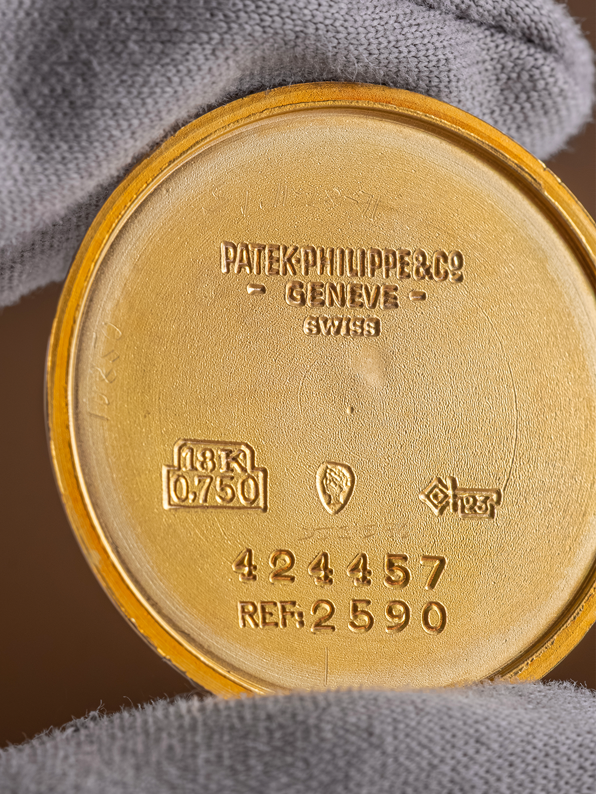 Gold case back with Patek Philippe branding and serial number