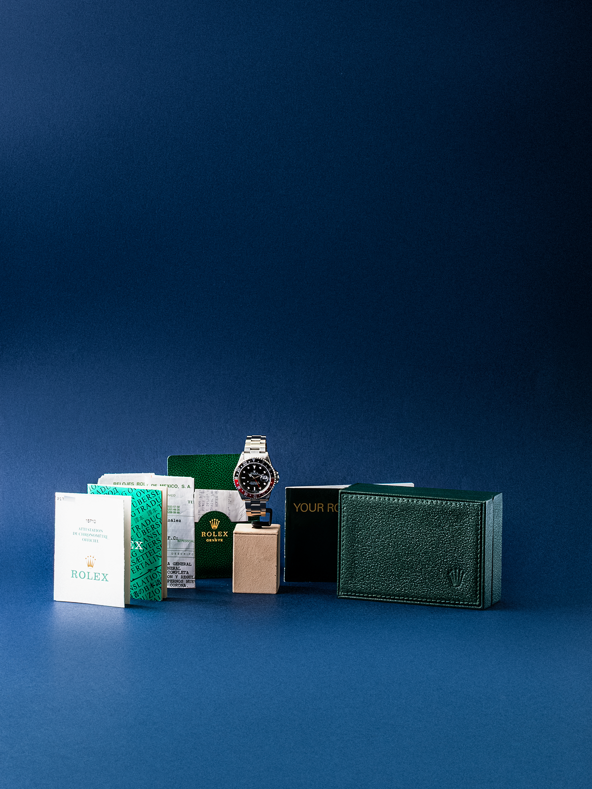 Collection of luxury watches and boxes on a blue background