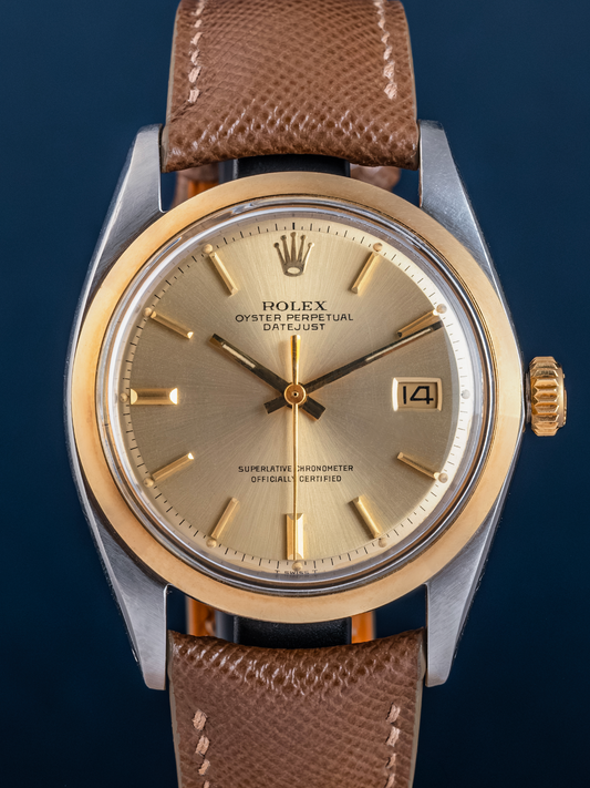 Rolex watch with brown leather strap on a dark blue background
