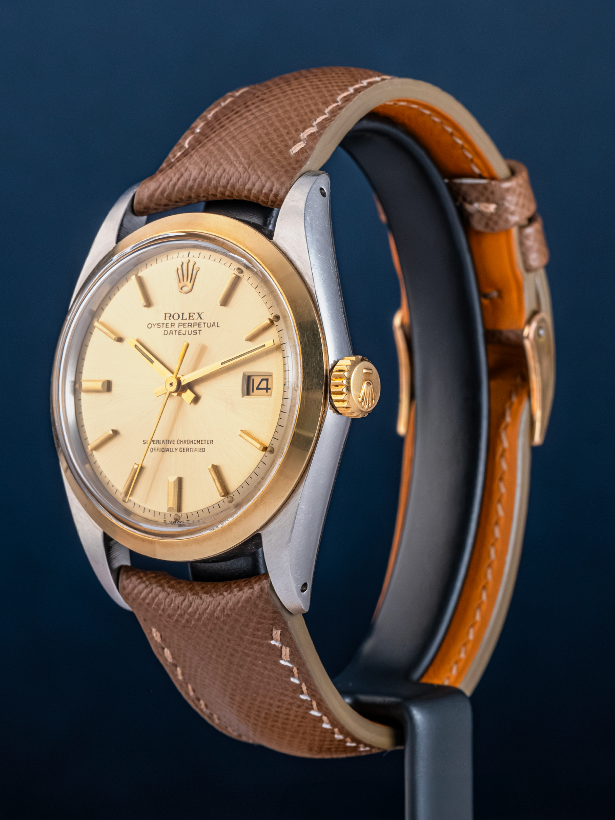 Rolex watch with brown leather strap on a dark background