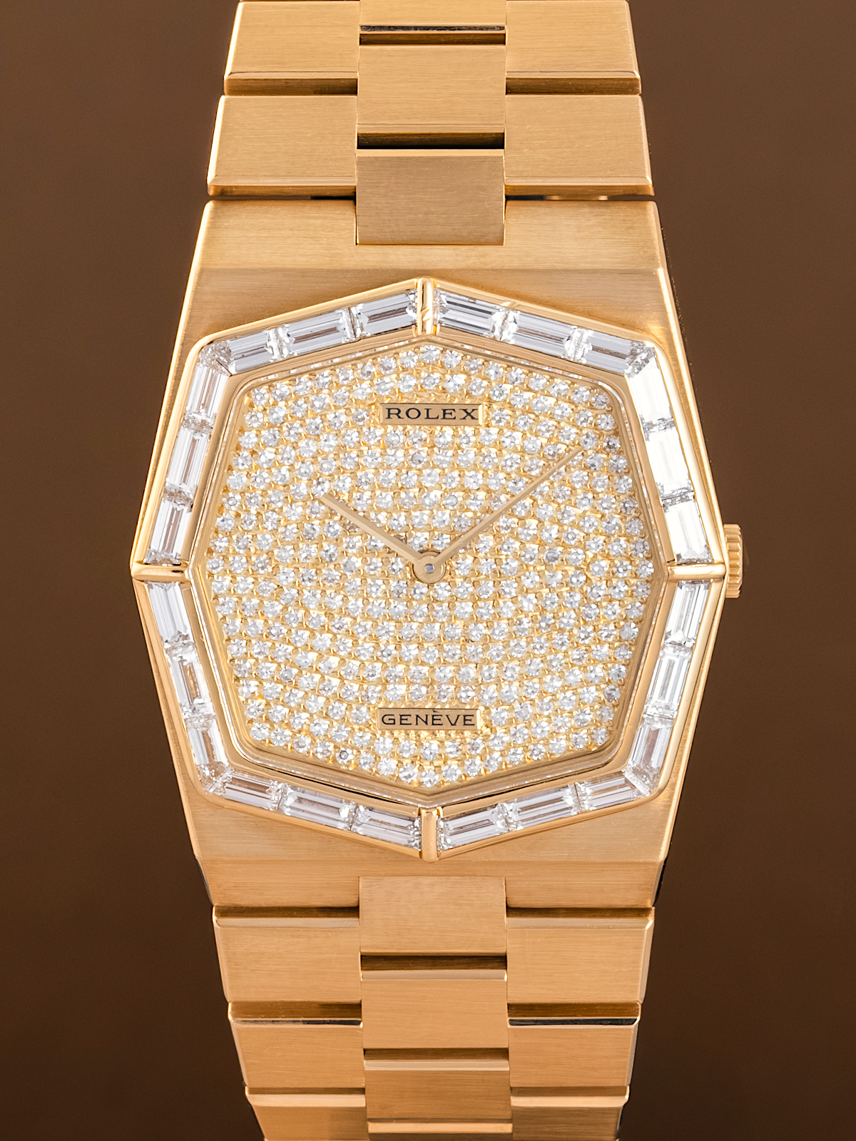 Gold Rolex watch with diamond-studded face on a brown background