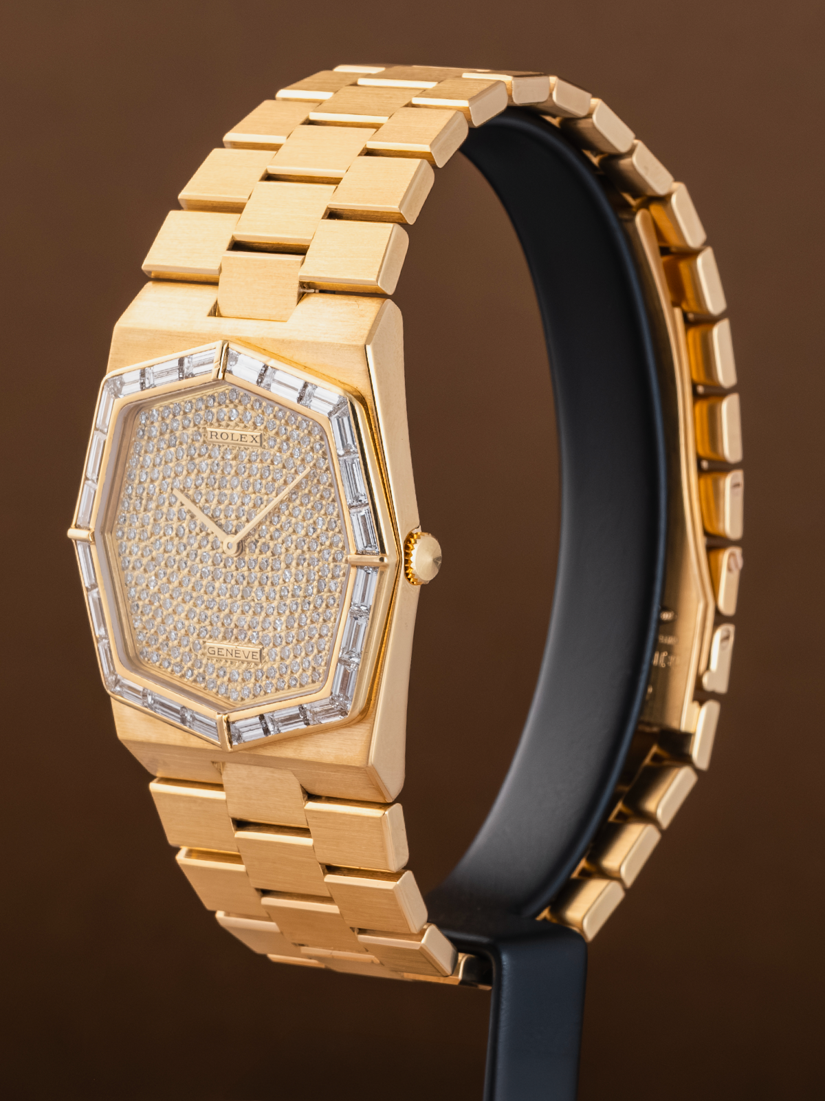 Gold watch with diamond-studded face on a brown background