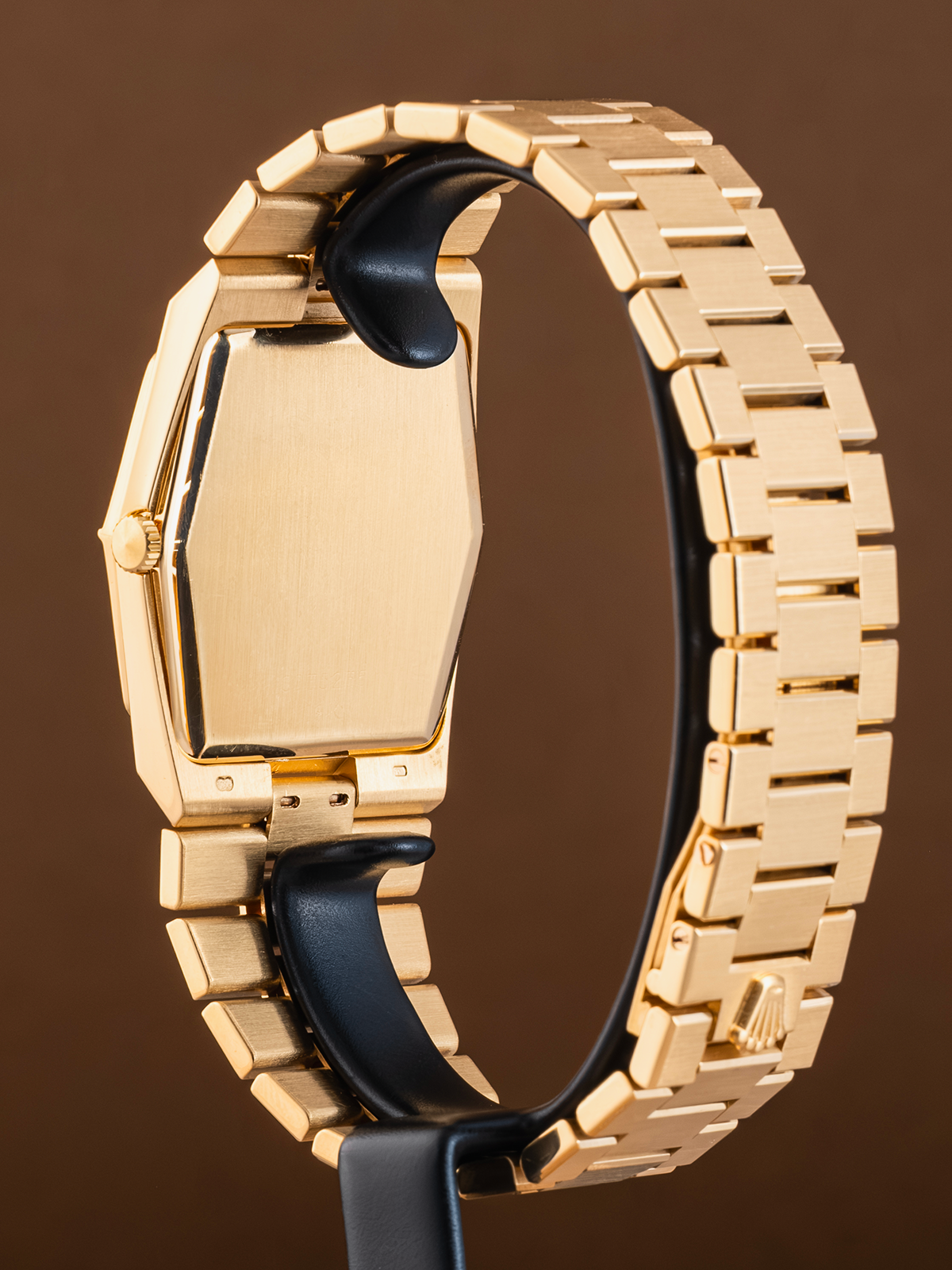 Gold metal bracelet with a brown background