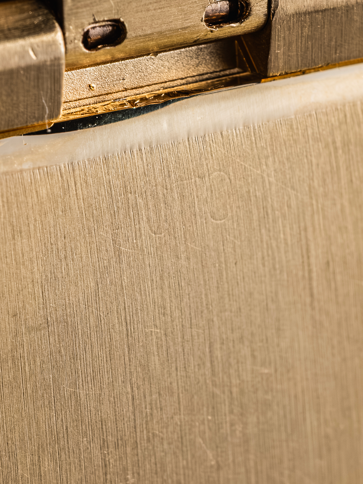 Close-up of a cardboard box corner with a metal fastener.