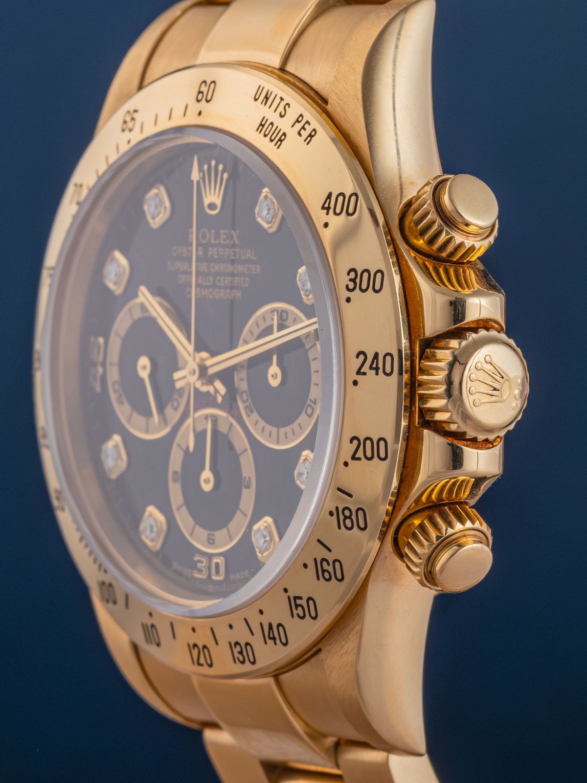 Gold watch with a blue face on a dark background