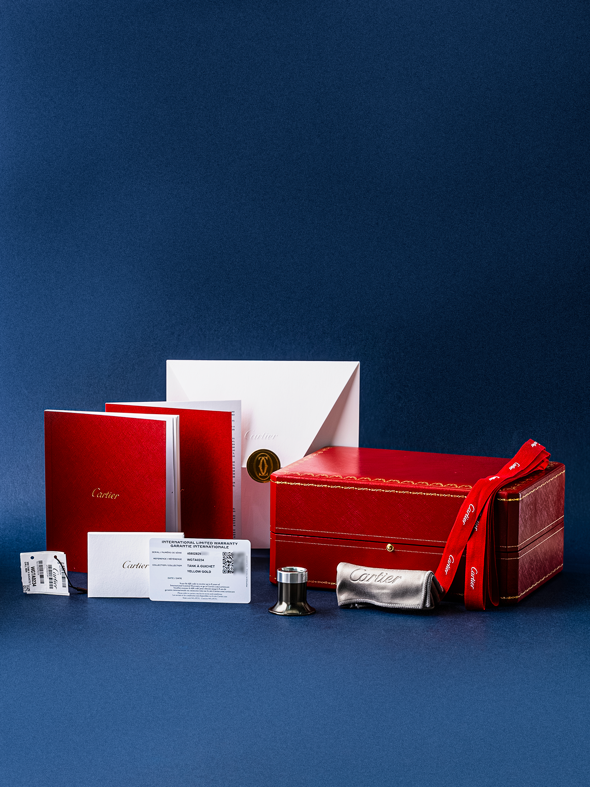 Red jewelry box with a bow on a blue background