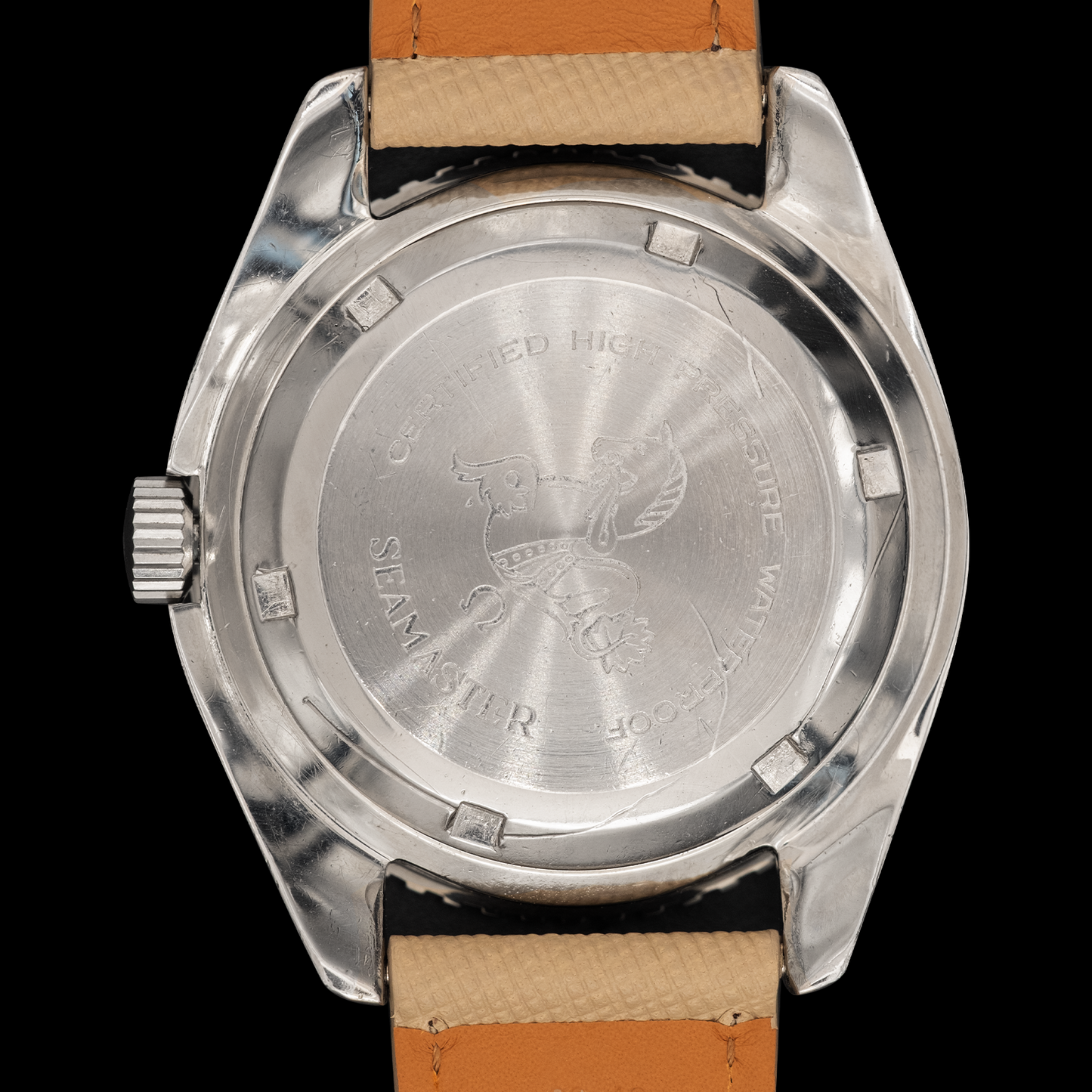 Back view of a silver watch with a brown leather strap on a black background
