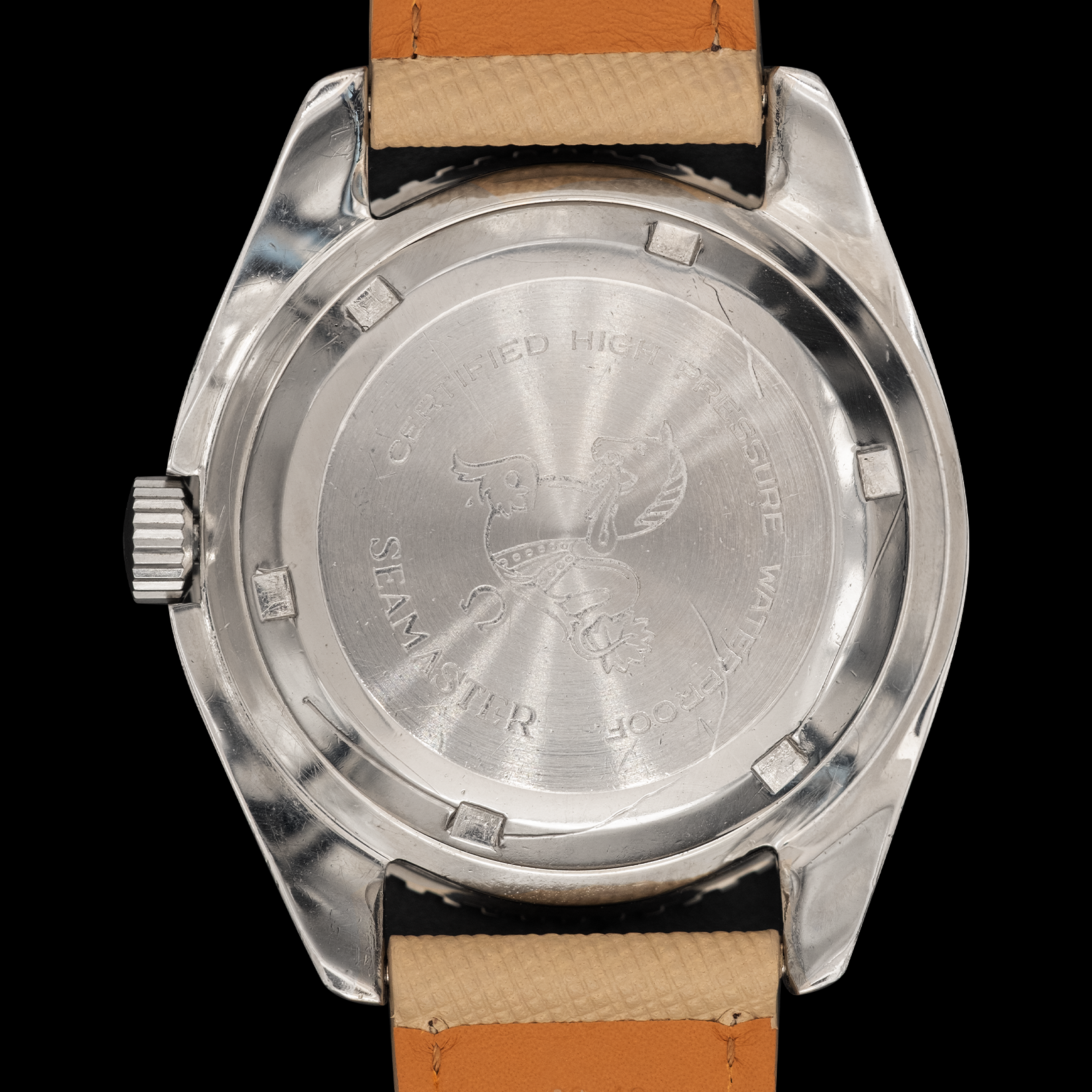 Back view of a silver watch with a brown leather strap on a black background