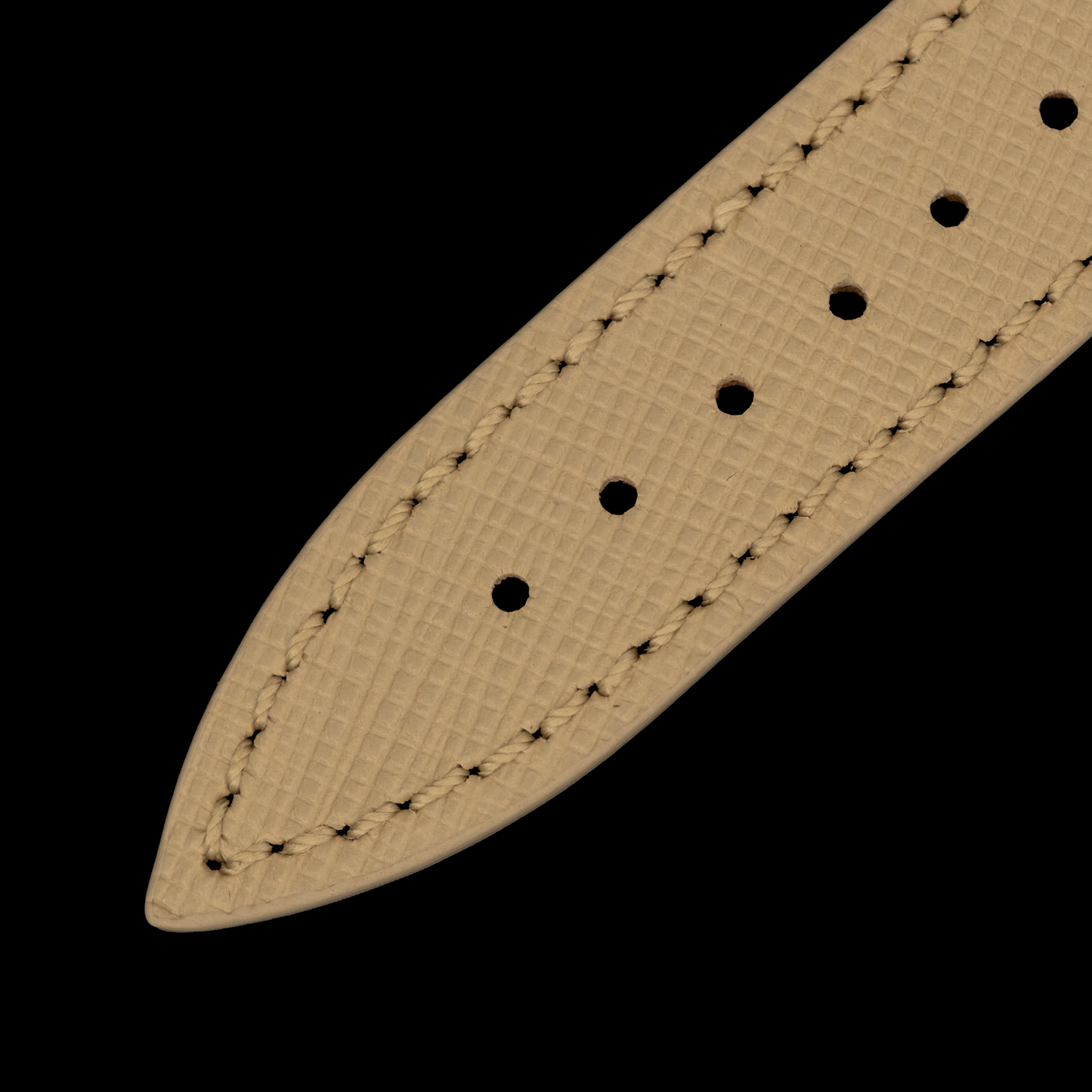 Beige leather belt strap with stitching on a black background