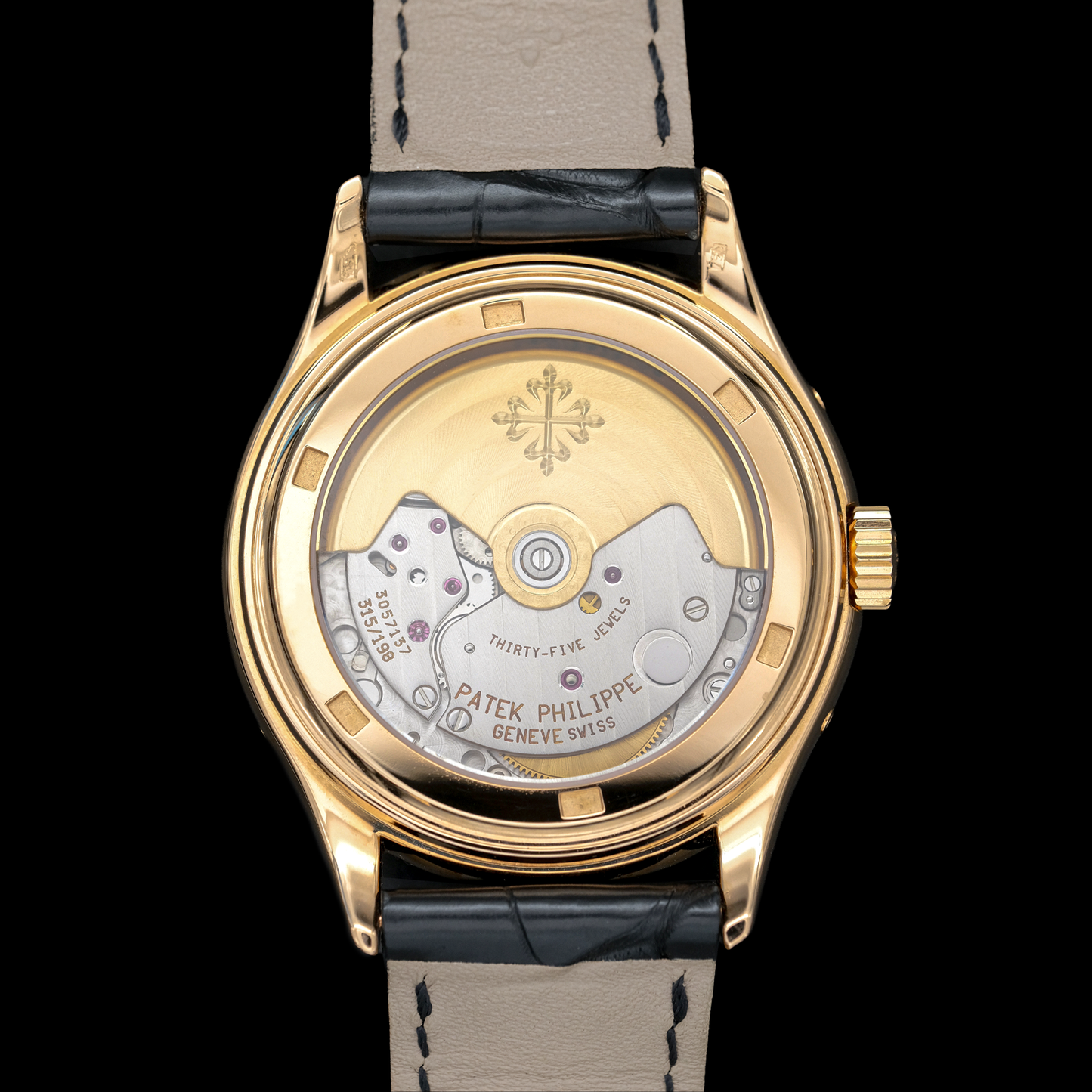 Gold watch with black strap on a white background